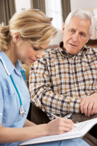 Carer listening to resident and writing