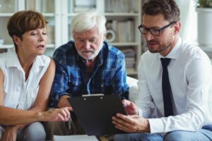 A care worker and service user with family member undertaking care planning