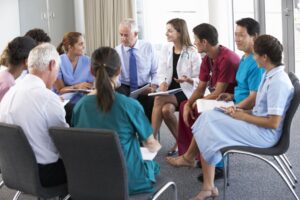 Staff seated in a circle discussing duty of candour